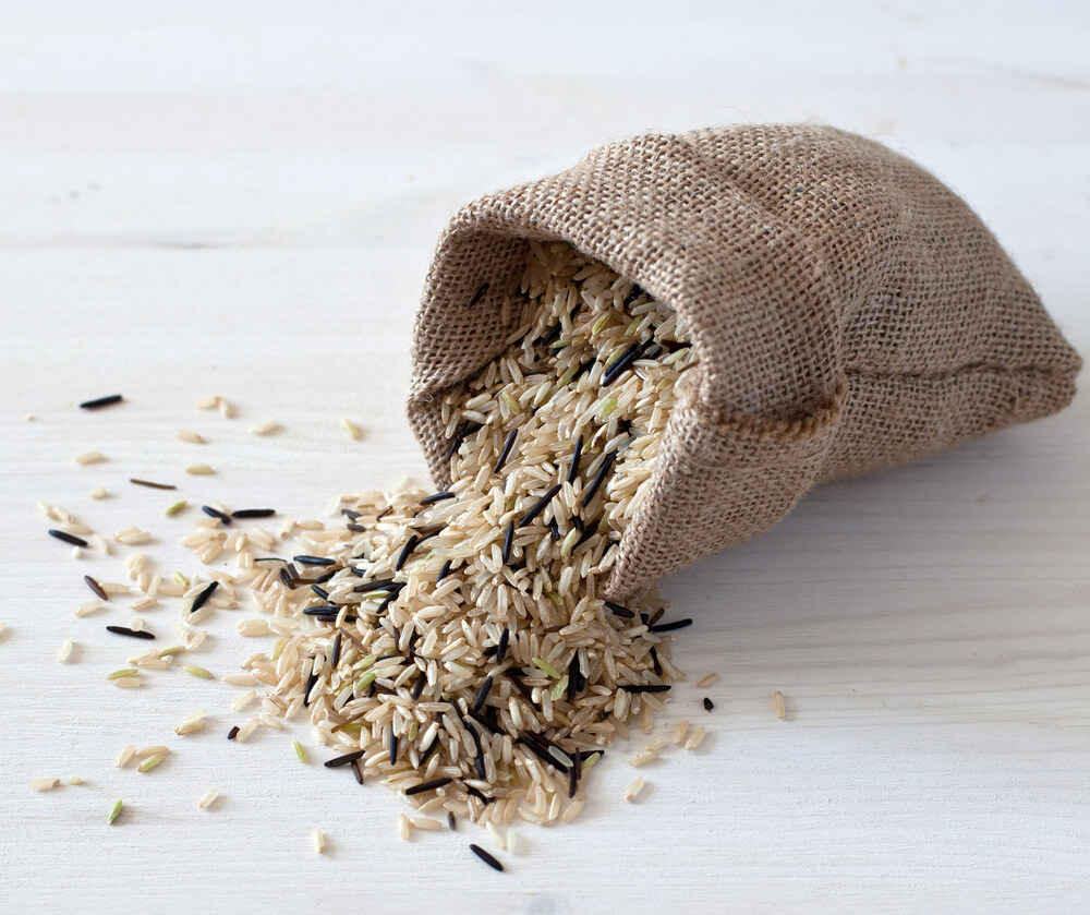 Image of wild rice spilling out of a burlap sack.