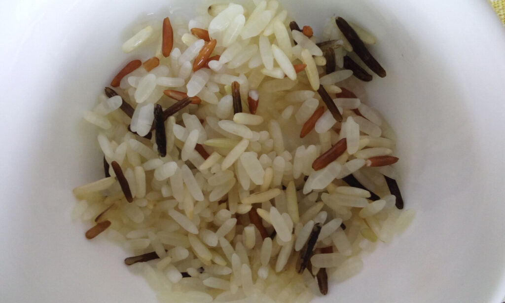 Image of cooked wild rice in a white bowl.