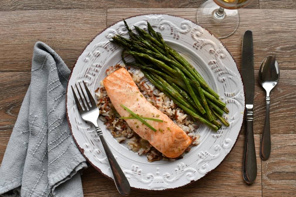 Image of roasted salmon, asparagus, and a bed of wild rice.